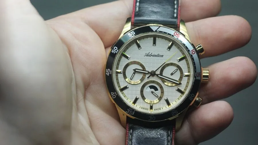 Person displaying various watch band materials including leather, silicone, and metal options on wrist