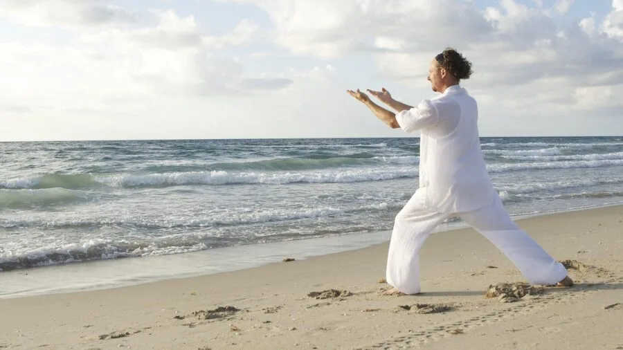 Person doing yoga on eco-friendly mat in natural outdoor setting with green surroundings