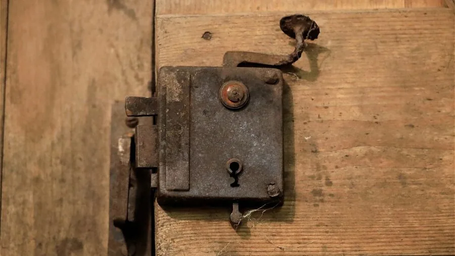 Person drilling precise hole into metal enclosure box during industrial equipment installation work