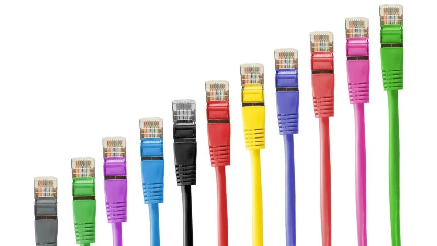 Person easily connecting network cables to a switch, demonstrating simple plug-and-play setup without configuration