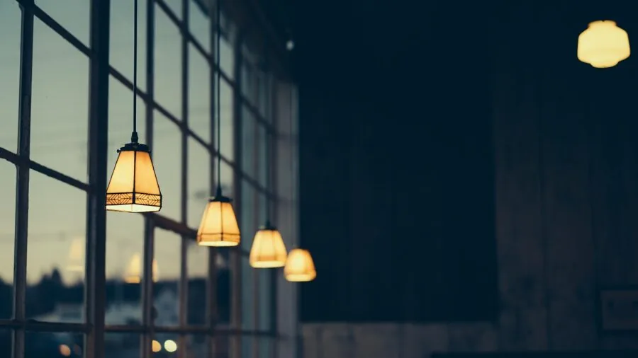 Person easily installing a light bulb into a ceiling fixture in a home interior