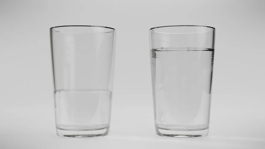 Person enjoying a glass of fresh mineral water in natural light