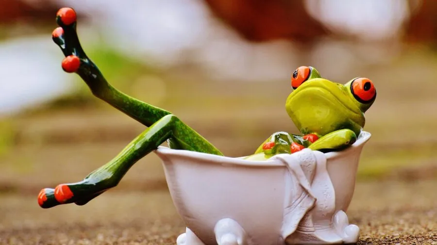 Person enjoying a relaxing bath with a pillow for comfort and support