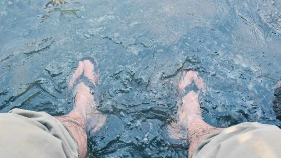 Person enjoying a warm foot soak at home for relaxation and comfort