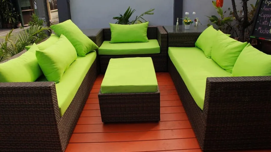 Person enjoying comfortable seating on an outdoor patio furniture setup in natural daylight