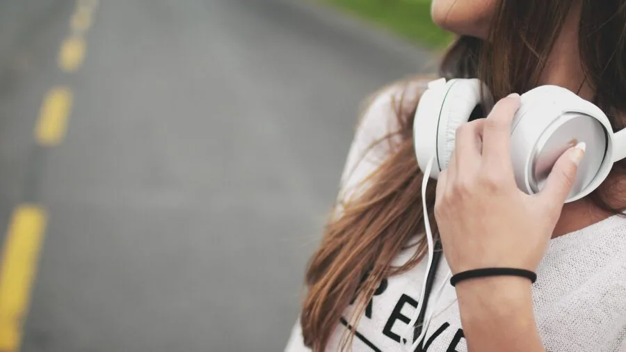 Person enjoying high-quality audio through headphones in a focused listening moment