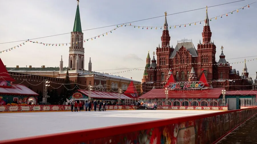 Person enjoying ice skating outdoors in winter, dressed warmly with cozy winter clothing
