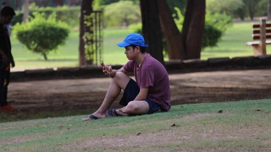 Person enjoying leisure time in a comfortable outdoor chair in a backyard setting