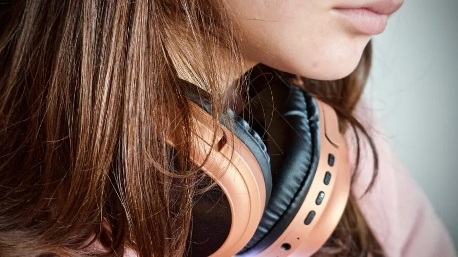 Person enjoying music wirelessly with headphones in a casual home setting