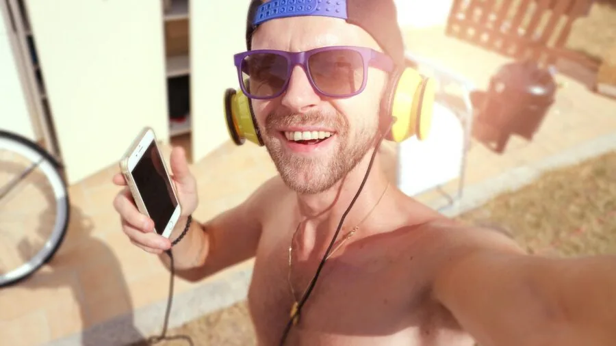 Person enjoying music with headphones in natural outdoor setting, lifestyle scene