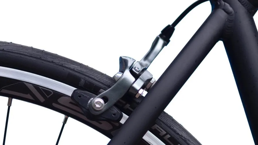 Person evaluating cycling equipment options while planning budget for new gear purchase