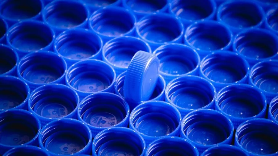 Person examining and comparing different sized bottles to evaluate product value and cost efficiency