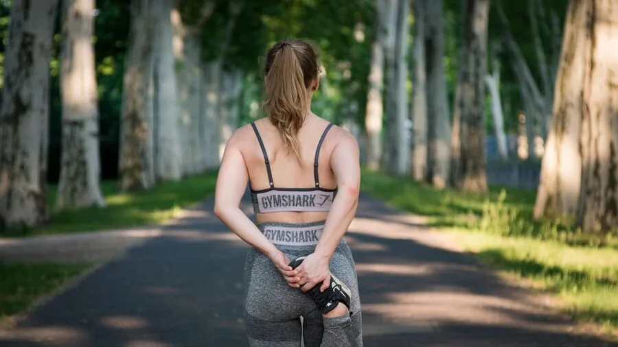 Person examining compression sleeve on arm during fitness activity
