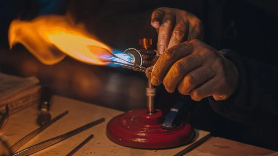 Person examining plastic tubing quality and construction details for durability assessment