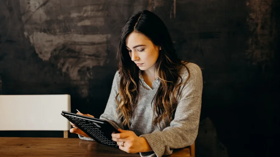 Person examining tablet display quality and text clarity in natural lighting