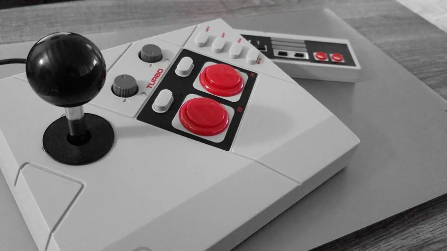 Person examining vintage gaming equipment, focusing on build quality and construction details of classic console hardware