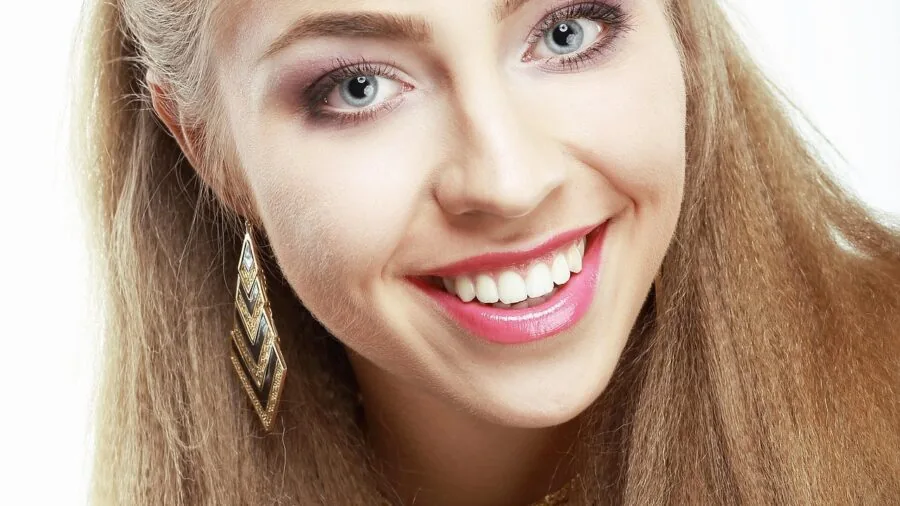 Person flossing teeth as part of daily dental hygiene routine