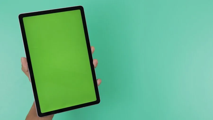 Person gently holding tablet with protective care, demonstrating screen safety practices