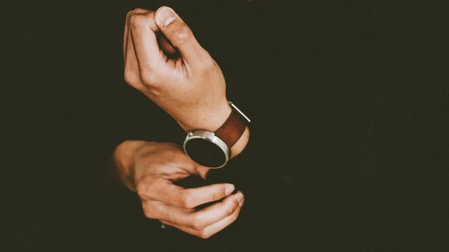 Person glancing at their wristwatch in a natural, everyday moment