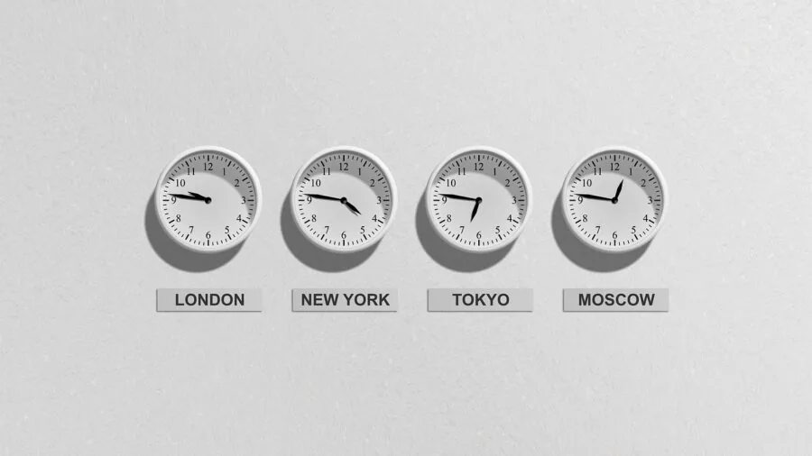 Person glancing at wall clock during daily routine, checking time in modern living space