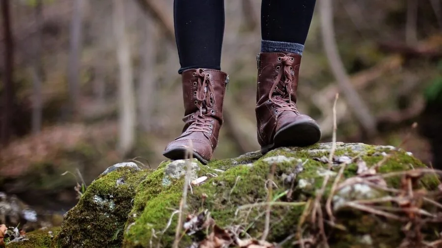 Person hiking on trail with dry, comfortable feet demonstrating moisture-wicking sock performance