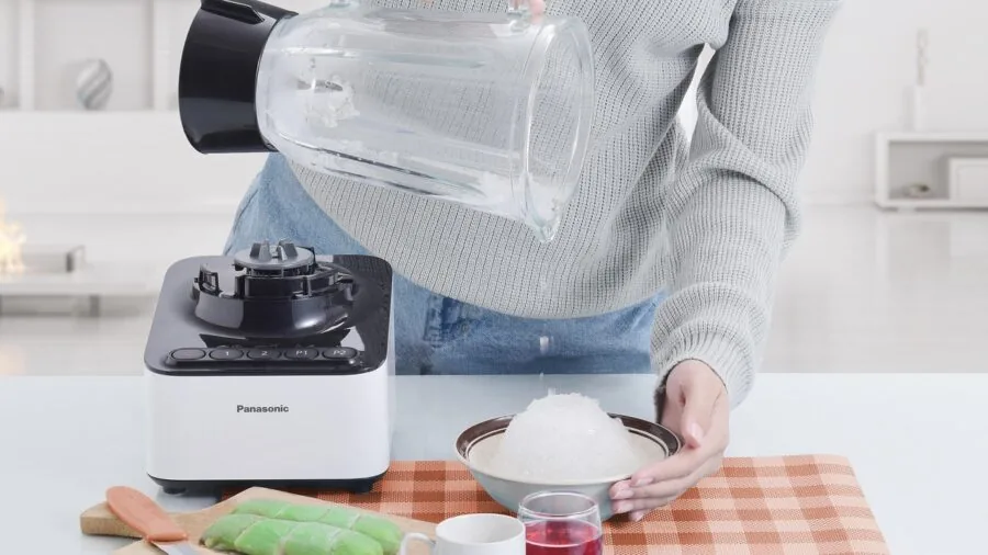 Person holding a cold beverage with crushed ice, lifestyle moment