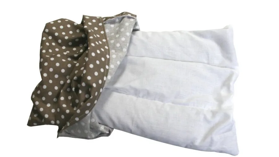 Person holding a hot water bottle for warmth and comfort during relaxation