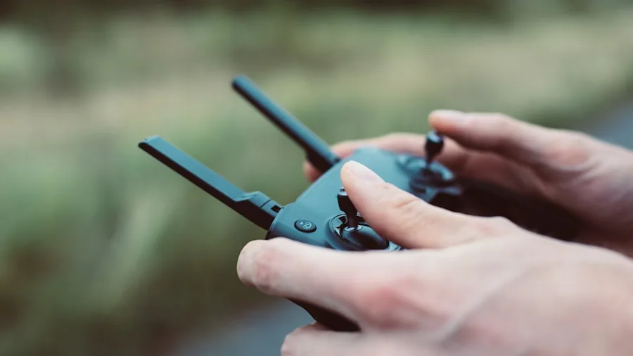 Person holding remote control outdoors during daytime, demonstrating RC device operation in open space