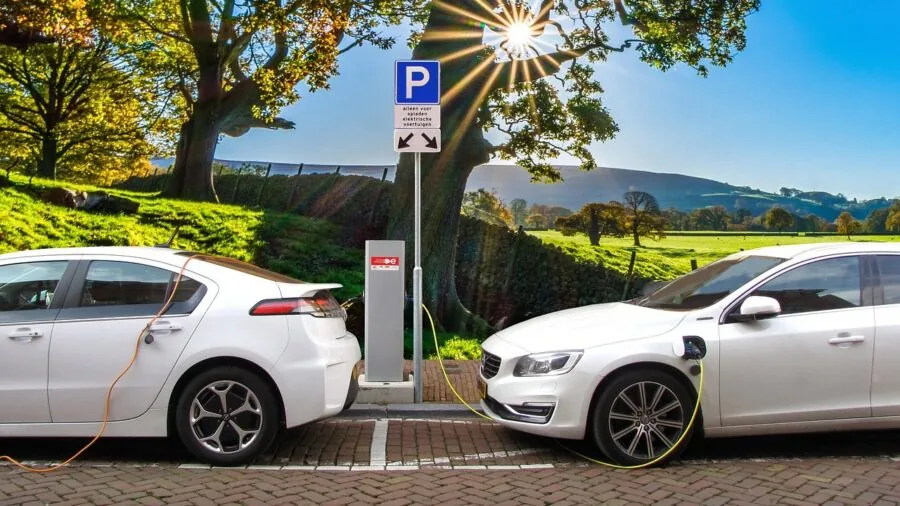 Person in car dashboard charging smartphone and tablet simultaneously during drive