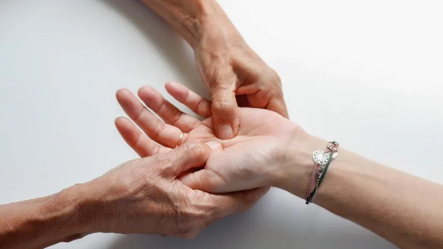 Person in casual home setting monitoring their heart health and wellness routine
