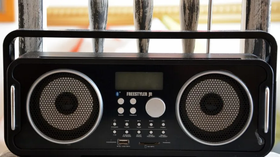 Person in home listening to weather radio during storm alert, emergency preparedness