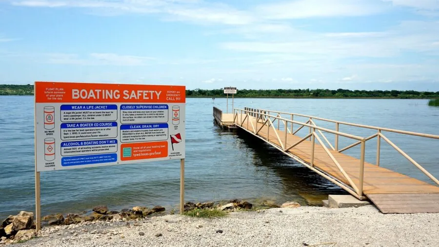 Person in life vest on boat enjoying water activities during sunny day