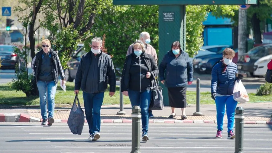 Person in residential yard wearing hearing protection while doing outdoor work