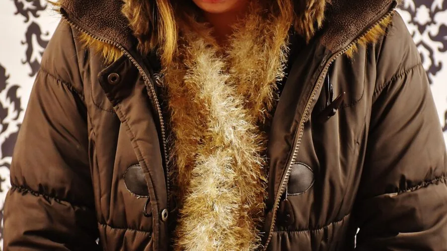 Person in warm wool scarf during cold weather, demonstrating fabric weight and warmth