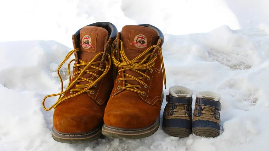 Person in winter boots standing outdoors in snowy landscape, evaluating footwear warmth and comfort