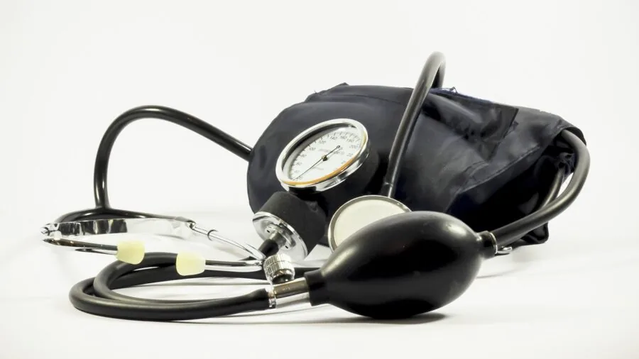 Person inflating bike tire and checking pressure gauge to ensure accurate PSI before riding
