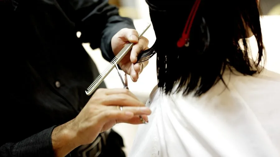 Person inspecting a durable hair comb up close to assess build quality and craftsmanship