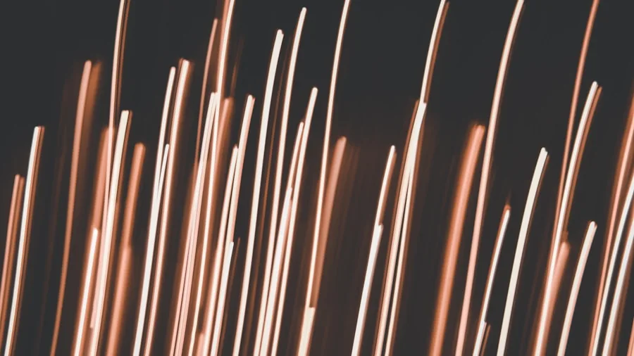 Person inspecting close-up details of copper electrical wire materials in natural lighting