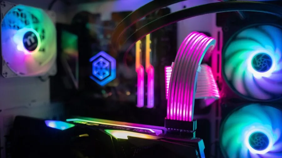 Person intensely focused while gaming on a high-performance PC setup during an immersive gaming session