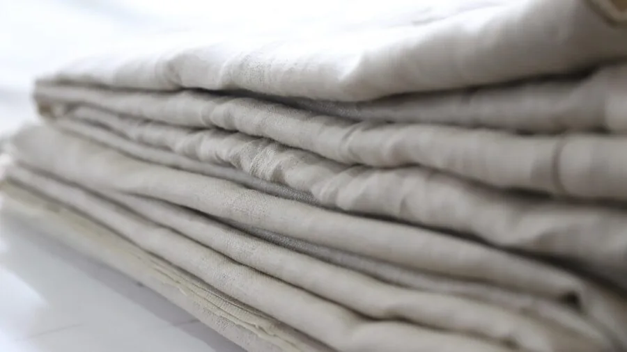 Person layering warm fabrics outdoors during cold weather activity