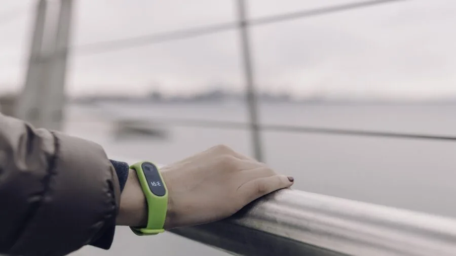 Person looking at fitness tracker during home workout session