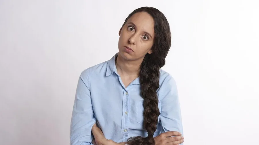 Person looking confused while assembling flat pack furniture at home