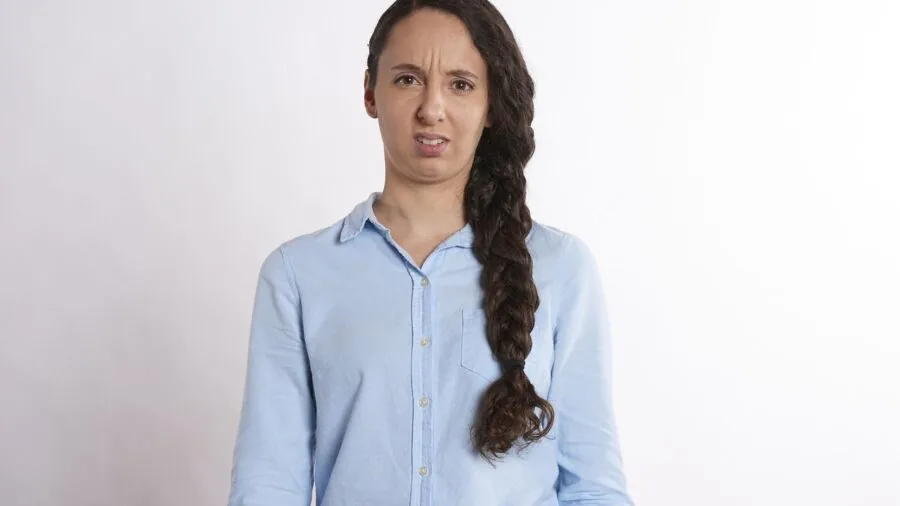 Person looking confused while reading technical documentation on screen, representing confusion about specs