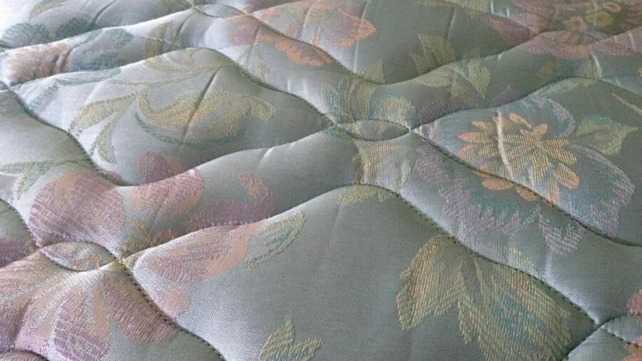 Person lying on mattress evaluating comfort and support for back pain relief