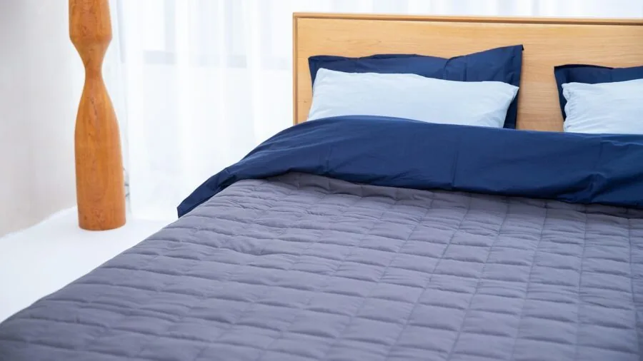 Person lying on mattress in bedroom, evaluating comfort and quality during trial period