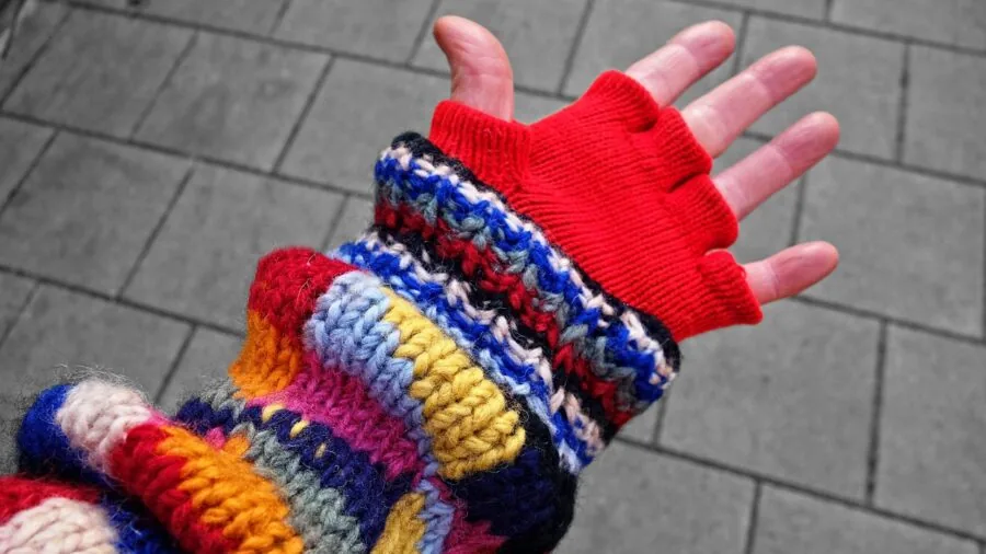 Person measuring arm circumference to determine proper compression sleeve sizing