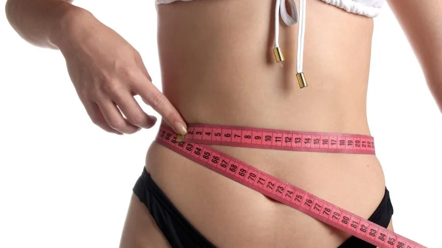 Person measuring body metrics and health data during fitness routine