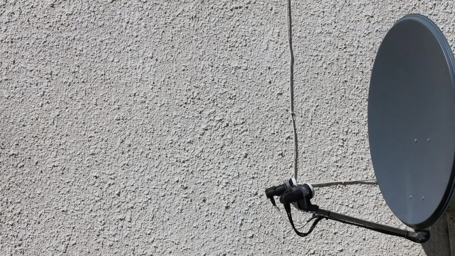 Person measuring wall space for TV mounting installation in modern living room