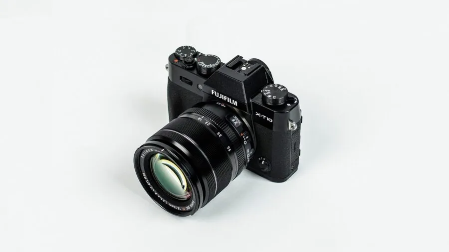 Person meticulously cleaning camera lens with professional care and precision