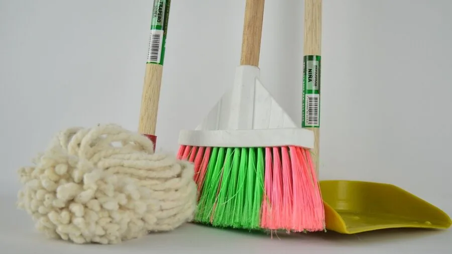 Person mopping hardwood floor in home, demonstrating practical cleaning routine and household maintenance